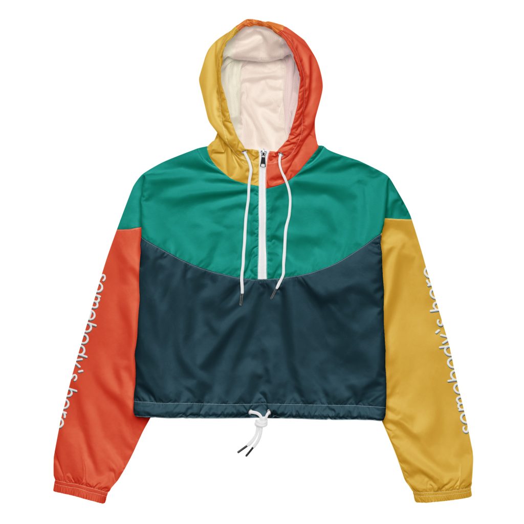 Image of Hero Basics' cropped windbreaker for women with somebody's hero on the sleeves