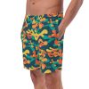 a man wearing a Hero Basics Recycled Camo Swim Trunks with a bright modern camouflage pattern