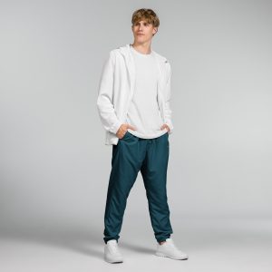 a man in a white shirt and dark teal Hero Basics Unisex Track Pants