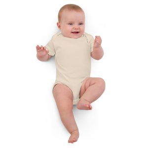 a baby girl lying on the floor wearing an organic cotton baby bodysuit by Hero Basics