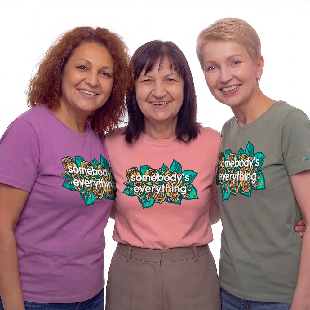 Three moms wearing colorful tee shirts with design of roses and and says somebody's everything.